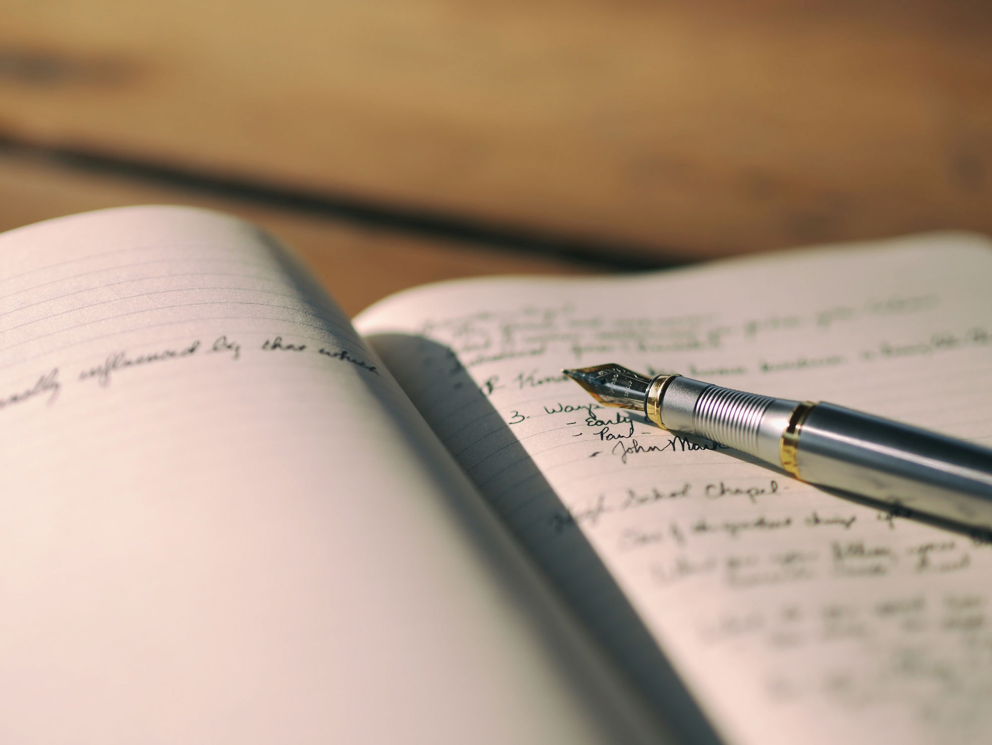 pen-on-white-lined-paper-selective-focus-photography.jpg pen on white lined paper selective focus photography